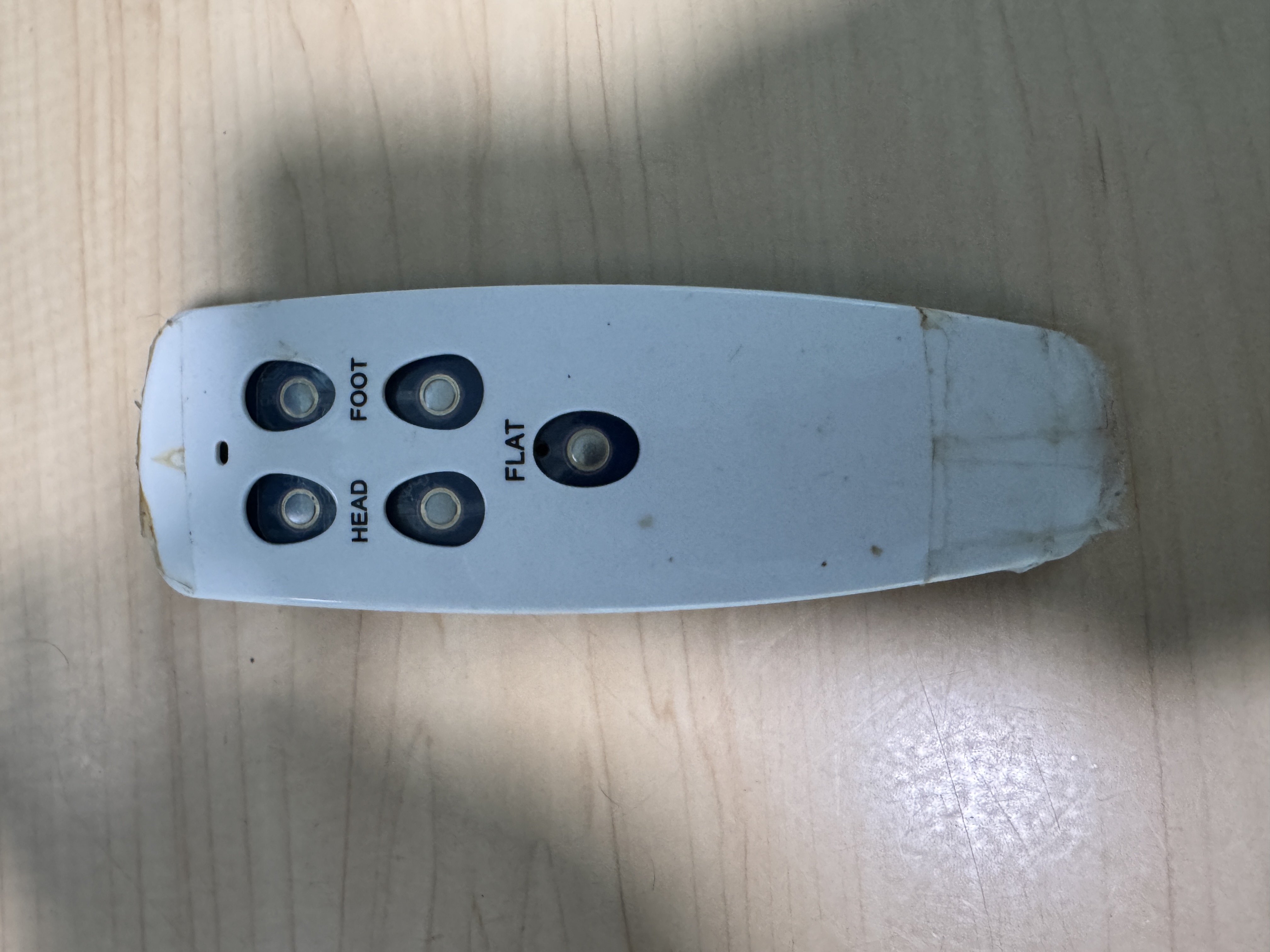 Original bed remote with worn, degraded buttons